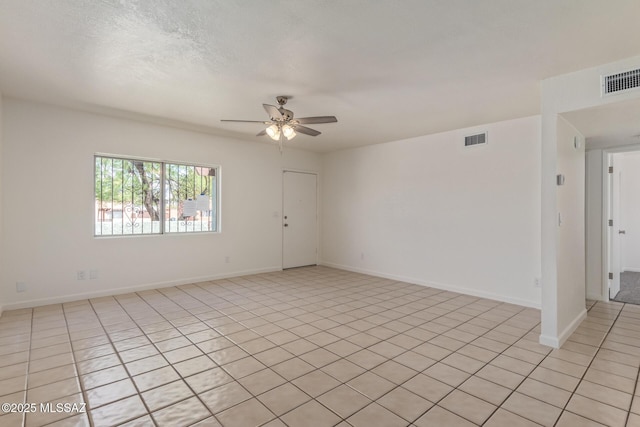 8341 E Placita Prado, Tucson, AZ 85710 - unfurnished room with ceiling fan, baseboards, and light tile patterned flooring