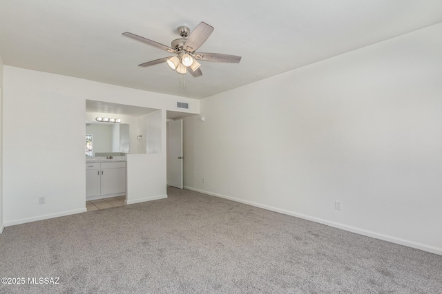 8341 E Placita Prado, Tucson, AZ 85710 - unfurnished bedroom featuring light colored carpet, ensuite bathroom, baseboards, and ceiling fan
