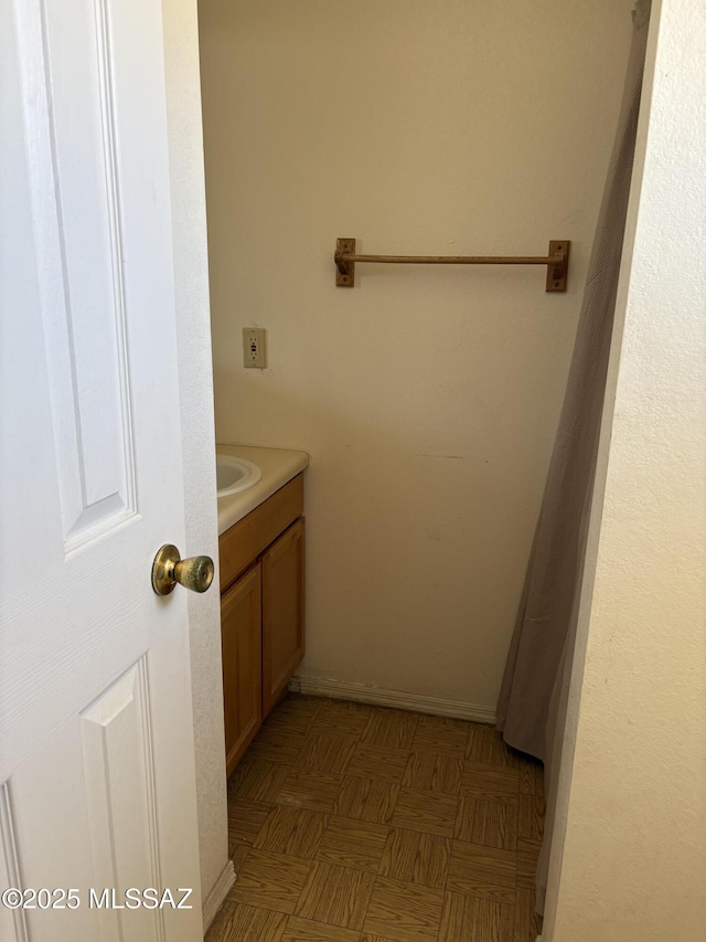bathroom featuring baseboards and vanity