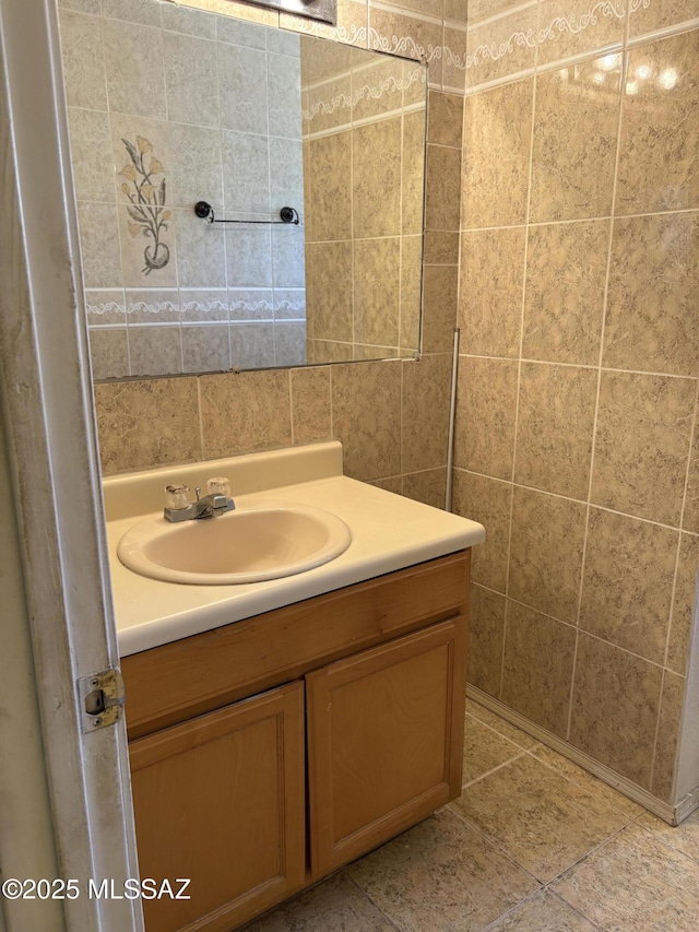 bathroom with tile walls and vanity