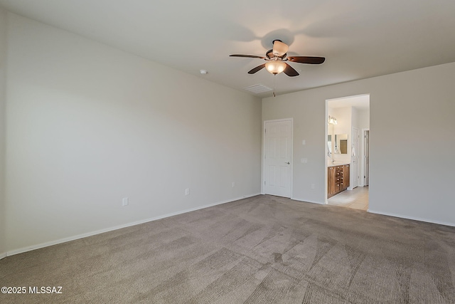 unfurnished bedroom with visible vents, light carpet, baseboards, ceiling fan, and ensuite bath