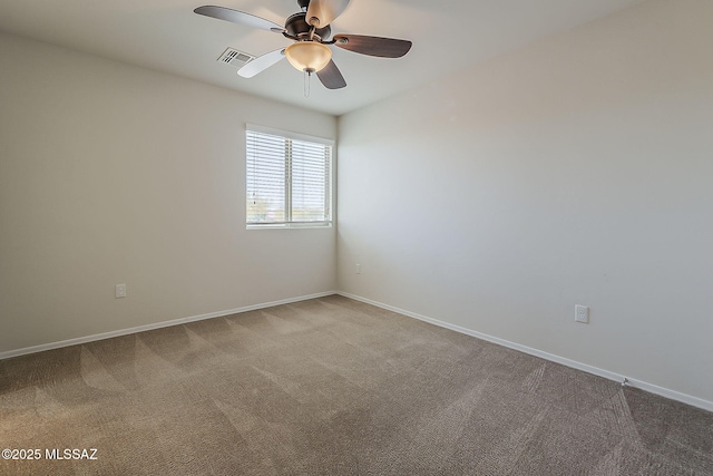 spare room featuring baseboards, carpet, a ceiling fan, and visible vents