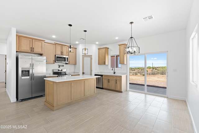 kitchen featuring a sink, baseboards, visible vents, light countertops, and appliances with stainless steel finishes