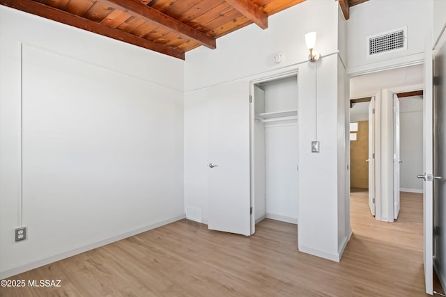 unfurnished bedroom with visible vents, wood ceiling, beam ceiling, and light wood-type flooring