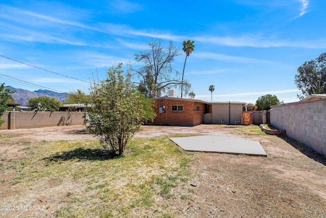 view of yard featuring a mountain view and a fenced backyard