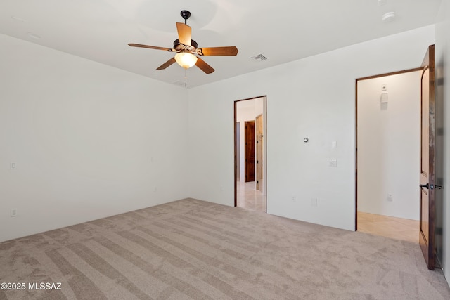 unfurnished bedroom with visible vents, a ceiling fan, and light carpet