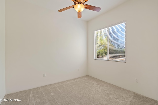 empty room with a ceiling fan and carpet