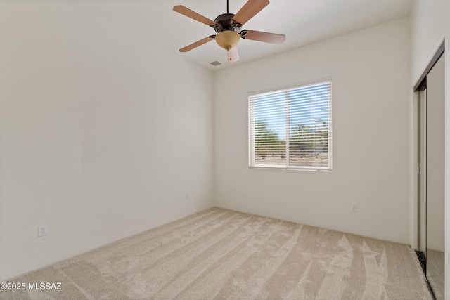 unfurnished bedroom with carpet flooring, ceiling fan, and a closet