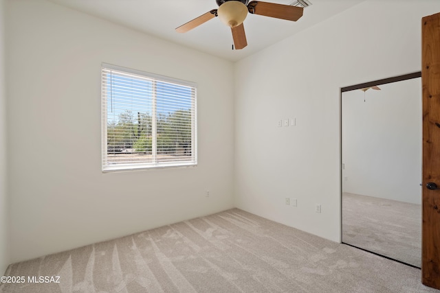 unfurnished room with carpet floors and a ceiling fan