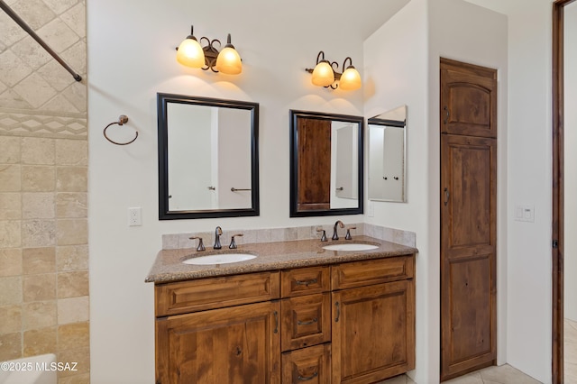 full bathroom featuring double vanity, a sink, and tile patterned flooring