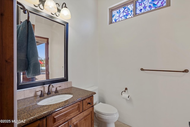bathroom featuring toilet and vanity