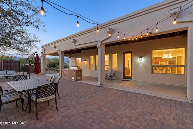 view of patio / terrace with fence, outdoor dining area, and exterior kitchen