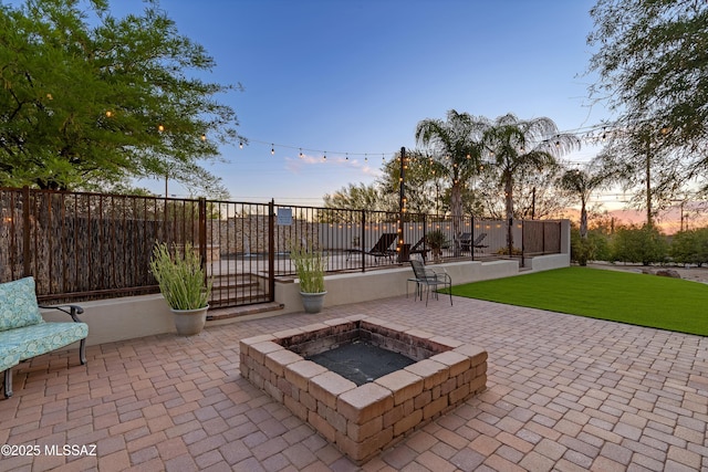 view of patio / terrace with fence and a fire pit