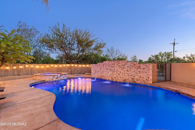 view of pool featuring an in ground hot tub, a fenced in pool, and a fenced backyard