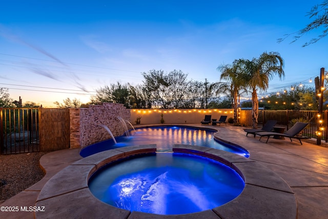 view of swimming pool with a fenced in pool, a fenced backyard, an in ground hot tub, and a patio area