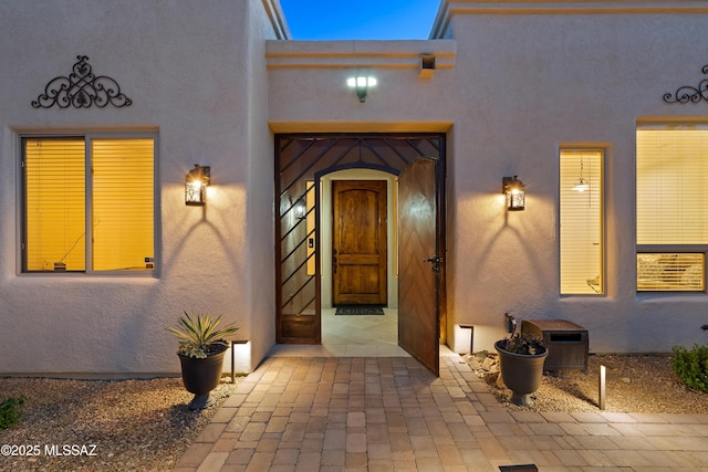 doorway to property with stucco siding