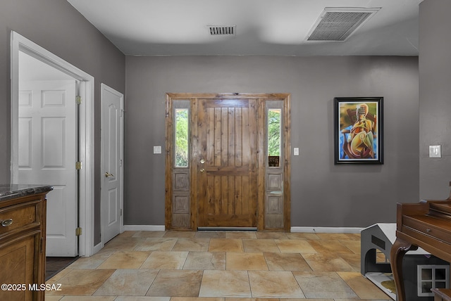 1351 Alma Ct, Rio Rico, AZ 85648 - foyer entrance featuring baseboards, visible vents, and stone finish flooring