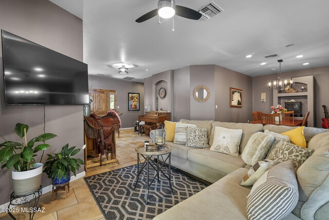 1351 Alma Ct, Rio Rico, AZ 85648 - tiled living room with visible vents, recessed lighting, and ceiling fan with notable chandelier
