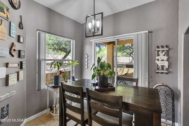 1351 Alma Ct, Rio Rico, AZ 85648 - dining room with light tile patterned flooring, an inviting chandelier, and baseboards