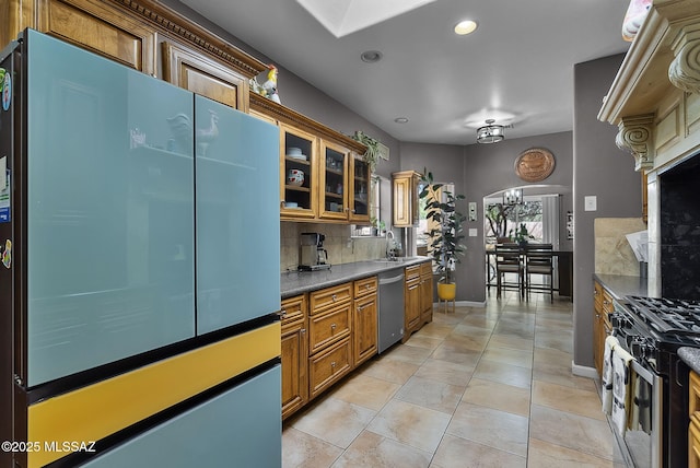 1351 Alma Ct, Rio Rico, AZ 85648 - kitchen featuring tasteful backsplash, glass insert cabinets, stainless steel appliances, brown cabinets, and dark countertops