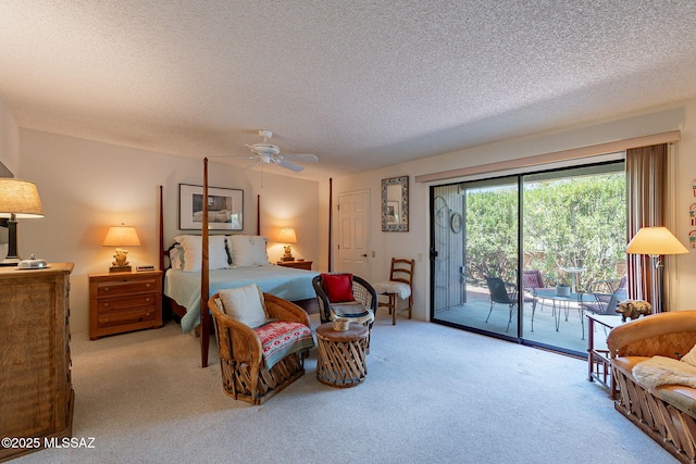 bedroom featuring carpet flooring, a textured ceiling, a ceiling fan, and access to exterior