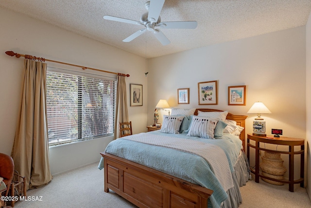 bedroom with light colored carpet, a textured ceiling, and ceiling fan