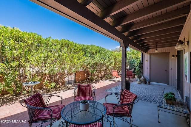 view of patio with fence and outdoor dining area