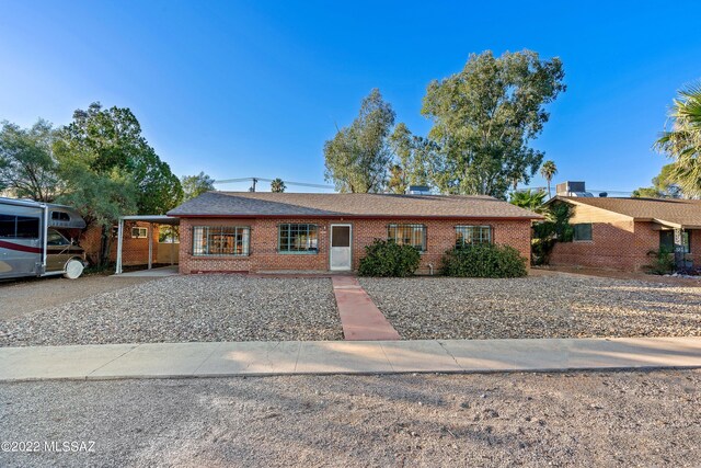 single story home featuring brick siding