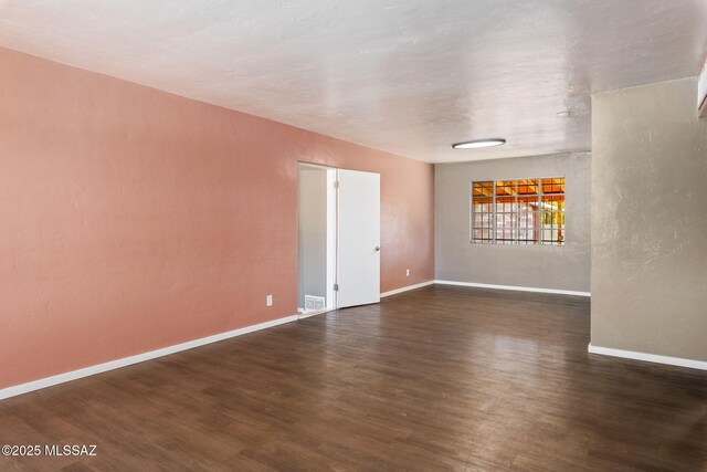 empty room with baseboards and finished concrete floors