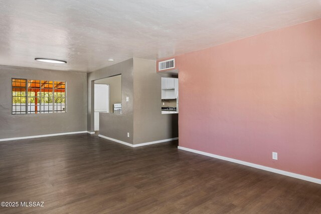 unfurnished room featuring baseboards, visible vents, and concrete flooring