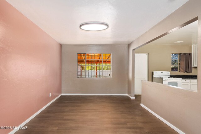 empty room with baseboards, a wealth of natural light, and concrete floors