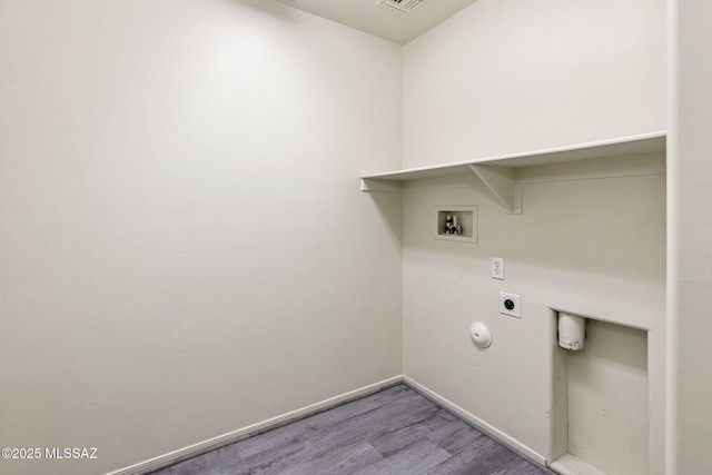 washroom featuring wood finished floors, hookup for a washing machine, electric dryer hookup, baseboards, and laundry area