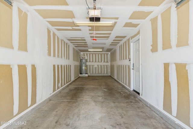 corridor with concrete flooring and water heater