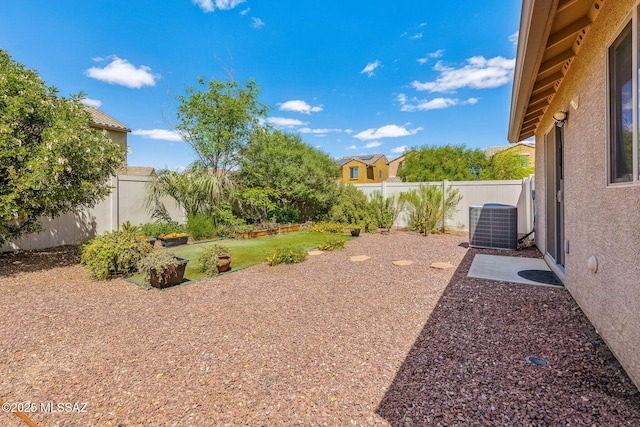 view of yard featuring central AC and a fenced backyard