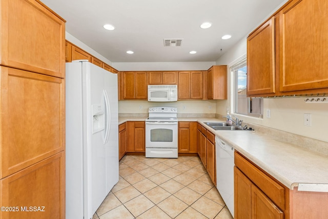 kitchen with a sink, light tile patterned flooring, visible vents, recessed lighting, and white appliances