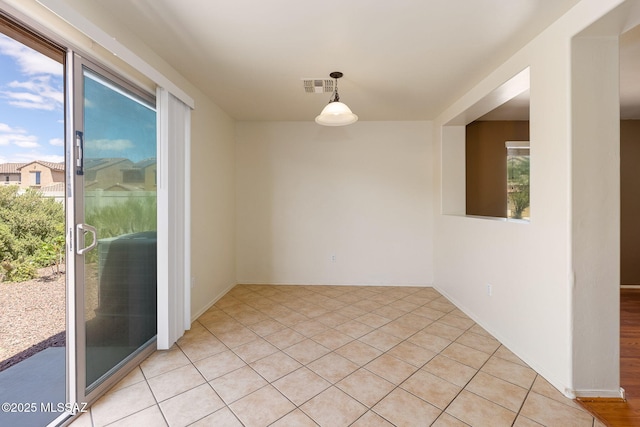 unfurnished room with visible vents and light tile patterned floors