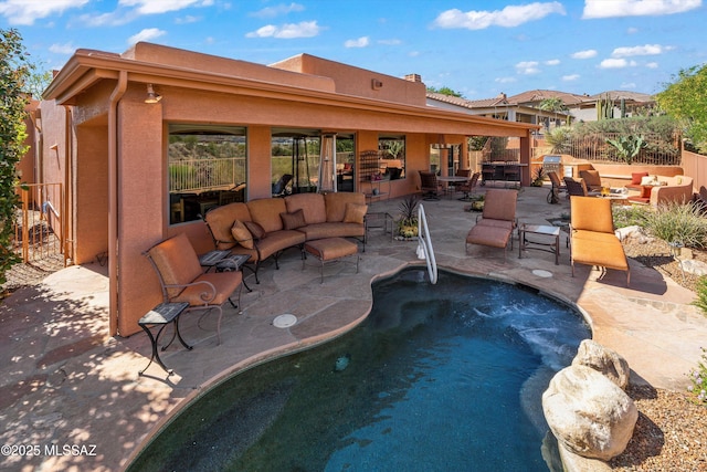 exterior space with a patio area and an outdoor living space with a fire pit