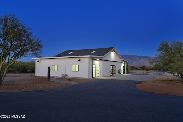 1720 W Cessna Way, Tucson, AZ 85755 - view of side of home with a mountain view, an outbuilding, stucco siding, and roof with shingles