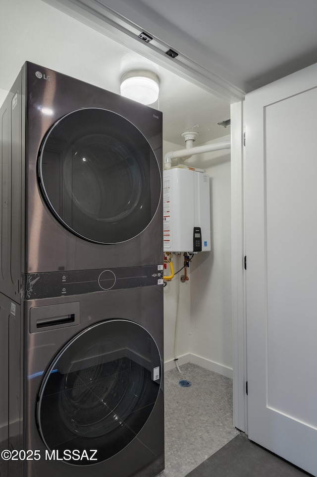 1720 W Cessna Way, Tucson, AZ 85755 - laundry area featuring stacked washer / drying machine, water heater, and baseboards