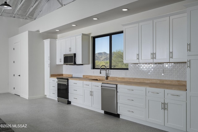 1720 W Cessna Way, Tucson, AZ 85755 - kitchen featuring stainless steel appliances, a sink, tasteful backsplash, butcher block counters, and baseboards
