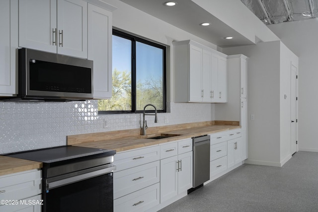 1720 W Cessna Way, Tucson, AZ 85755 - kitchen featuring appliances with stainless steel finishes, a sink, wooden counters, decorative backsplash, and baseboards