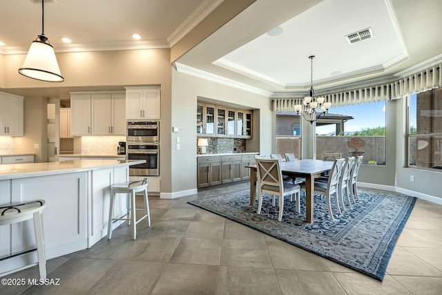 dining space featuring ornamental molding, visible vents, recessed lighting, a chandelier, and a raised ceiling