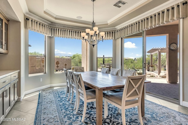 dining space with light tile patterned floors, ornamental molding, an inviting chandelier, and visible vents
