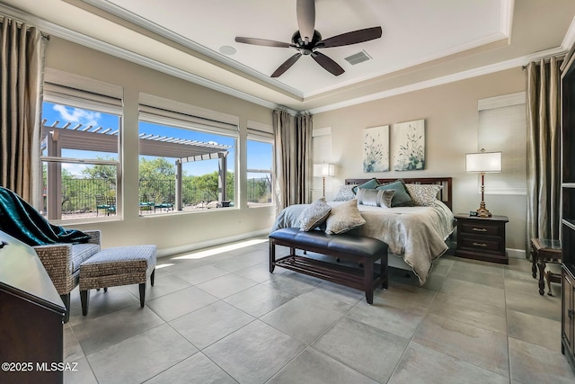 bedroom with a tray ceiling, crown molding, visible vents, baseboards, and ceiling fan