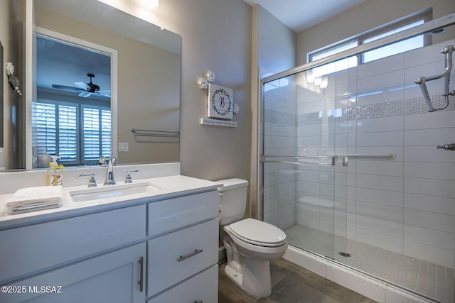 bathroom with toilet, a shower stall, and plenty of natural light