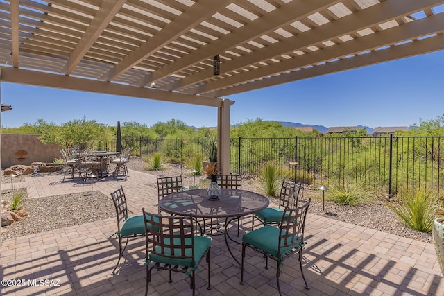 view of patio featuring a pergola, outdoor dining area, and a fenced backyard