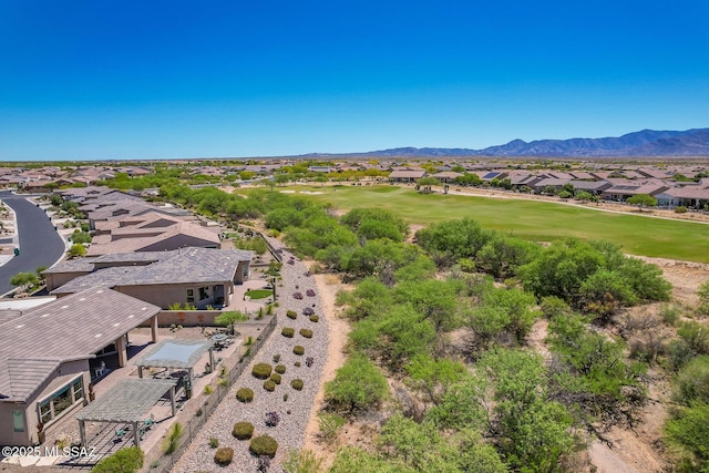 drone / aerial view featuring golf course view, a residential view, and a mountain view