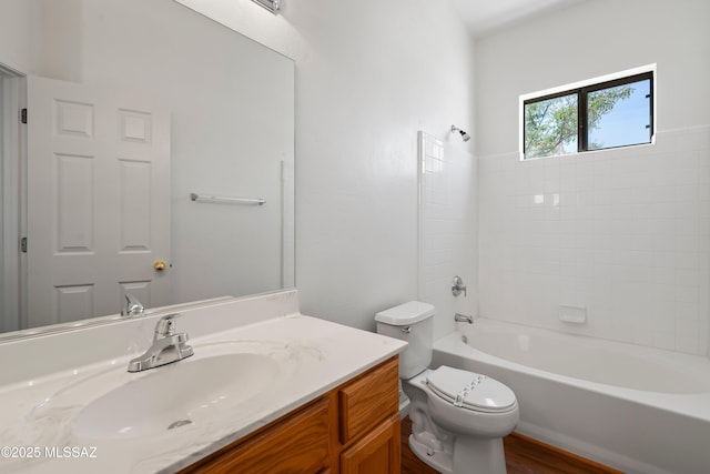 full bath featuring shower / bathtub combination, toilet, wood finished floors, and vanity