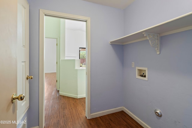 clothes washing area featuring baseboards, laundry area, hookup for a washing machine, and dark wood-type flooring