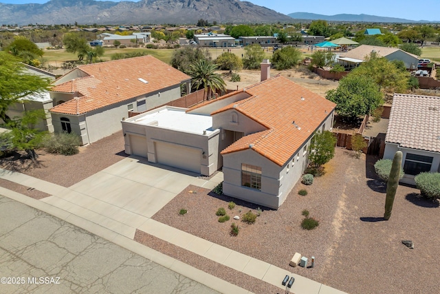 birds eye view of property with a mountain view and a residential view